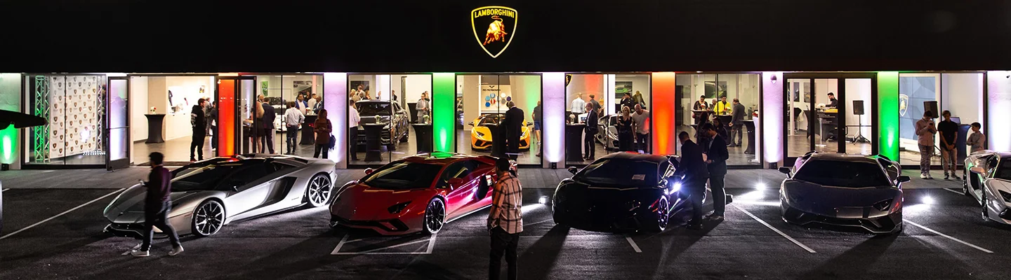 Line up of Lamborghinis in front of the Lamborghini store