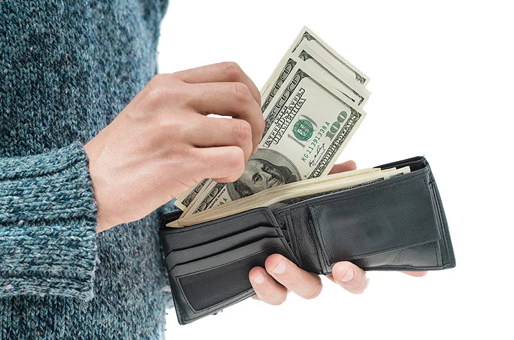 woman holding wallet getting money out