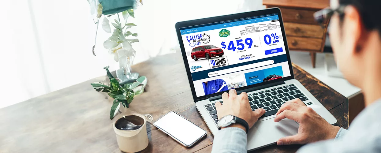 Man using his laptop to view the dealerships website from home