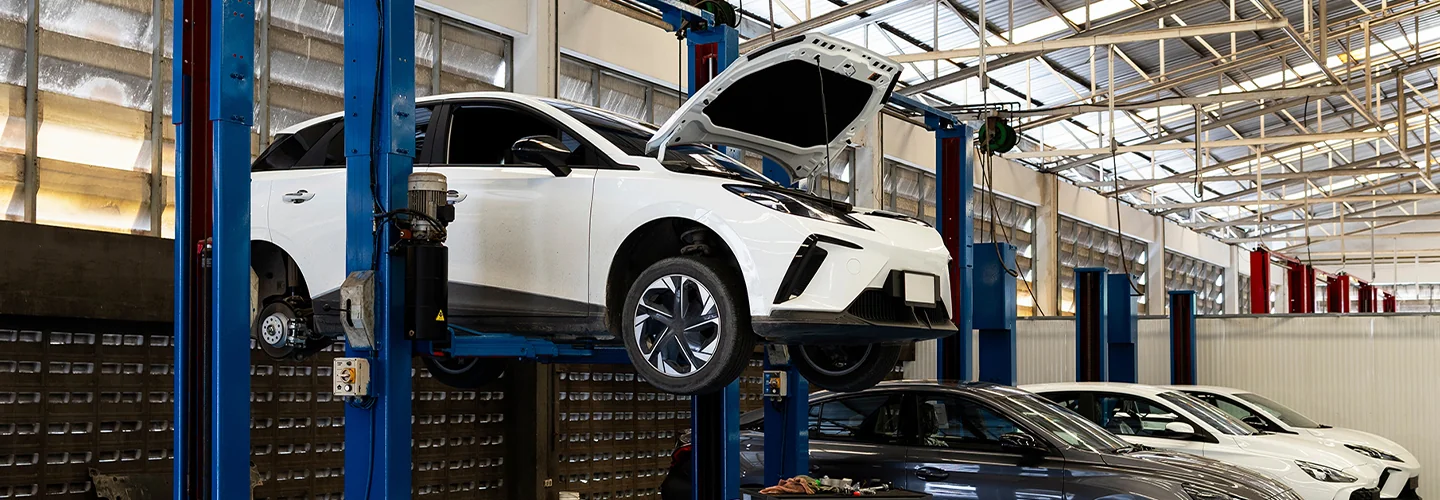 View of a Chevrolet service shop with a white Chevrolet EV on a service lift