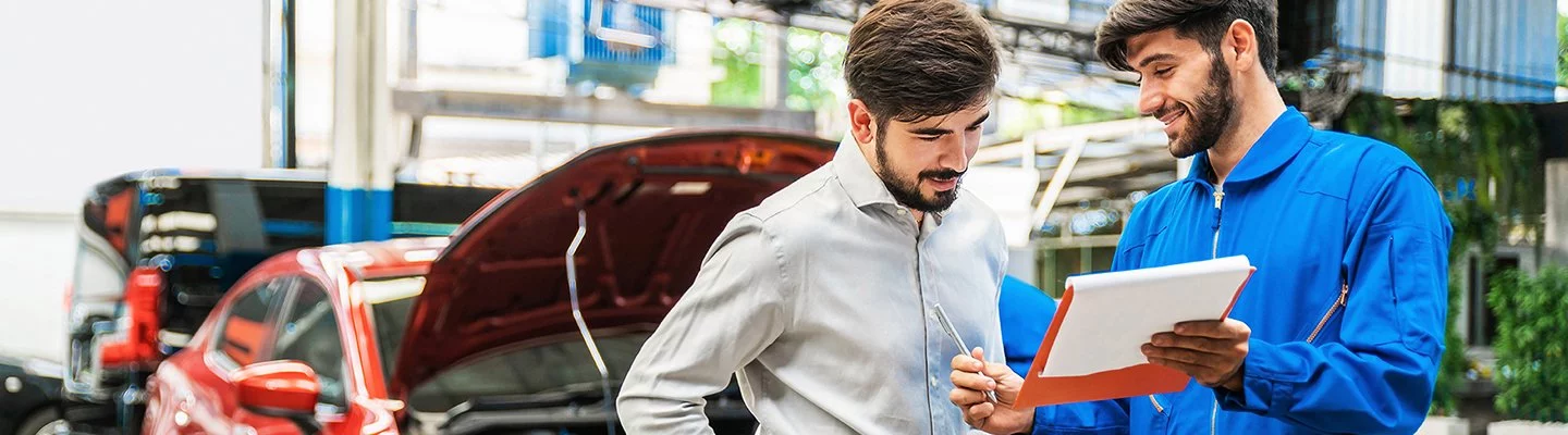 mechanic showing man a service report
