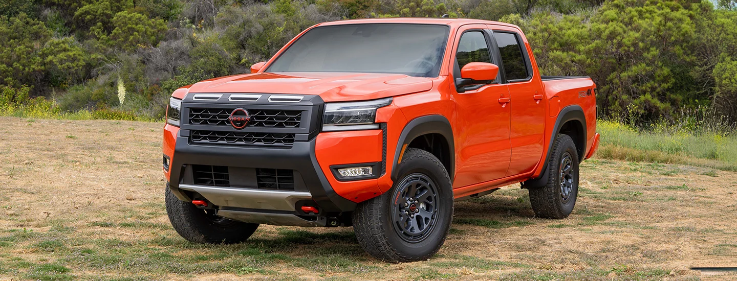 Orange Nissan Frontier truck parked
