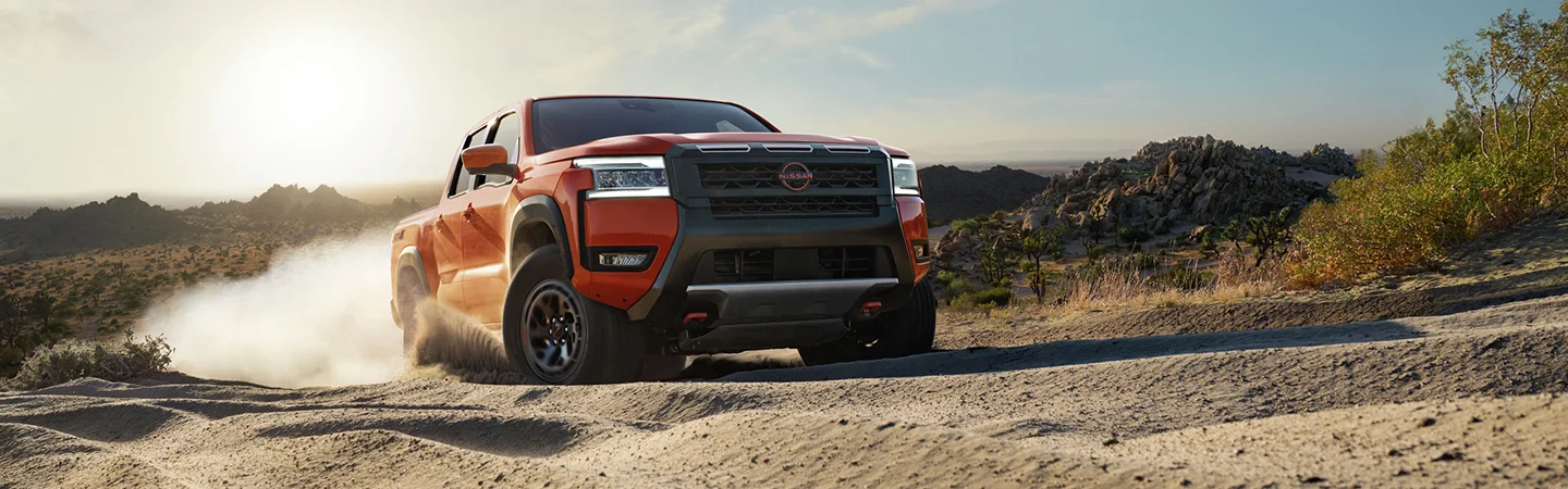 red Nissan Frontier on dirt