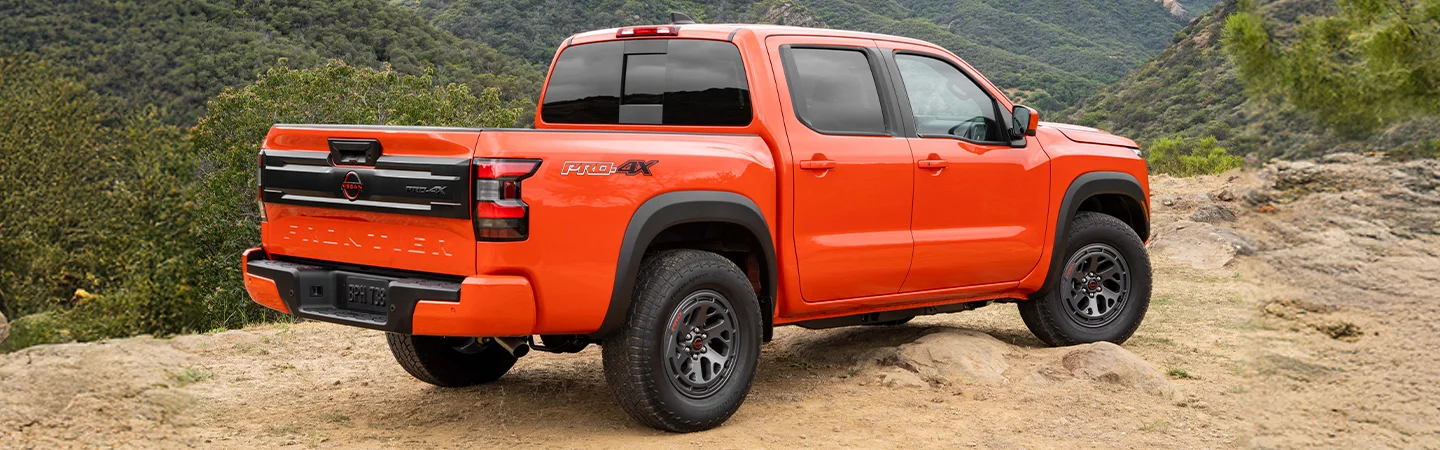 orange Nissan Frontier from rear
