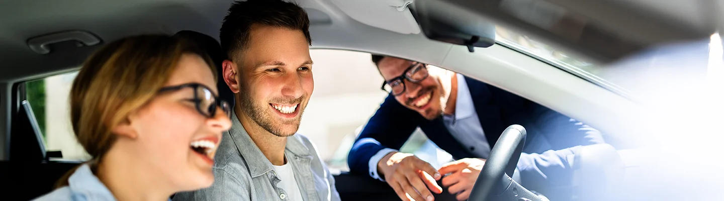 happy people sitting in new car