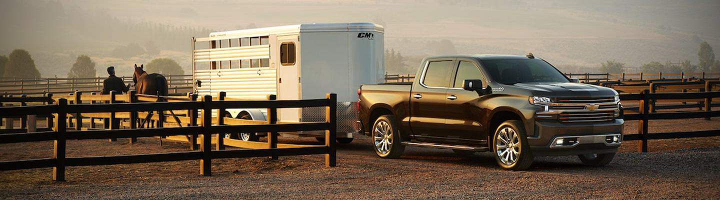Angled profile of a Chevy Silverado with a horse trailer attached