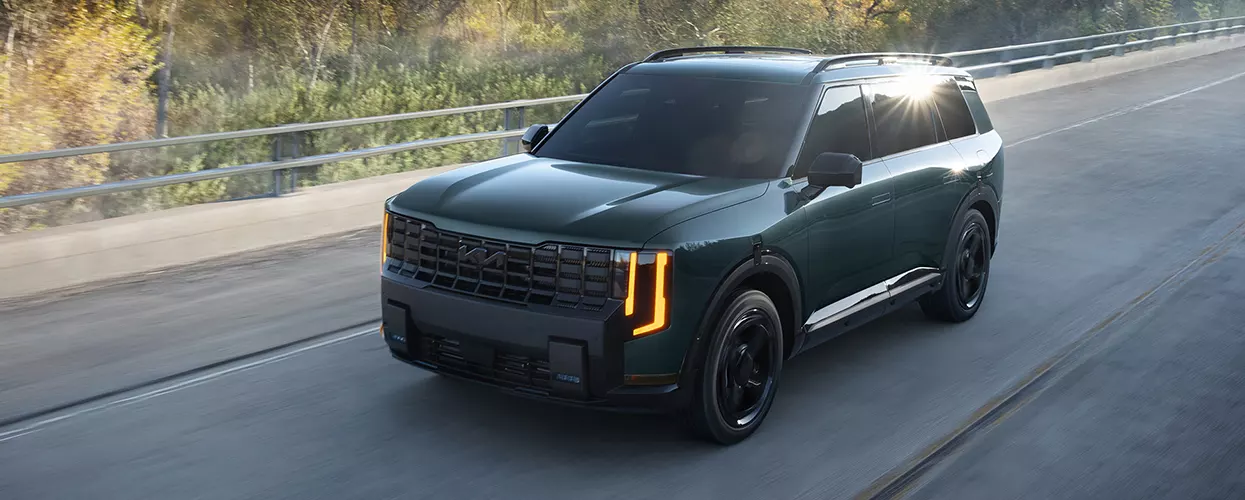 Kia Telluride Hybrid driving down a back road