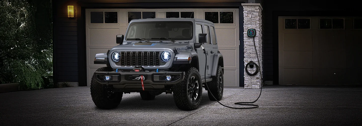 Jeep Wrangler charging up by a home