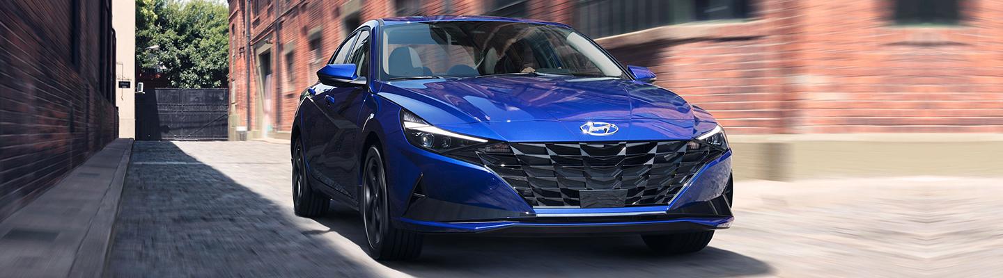 Angled front profile of a blue Hyundai vehicle in motion