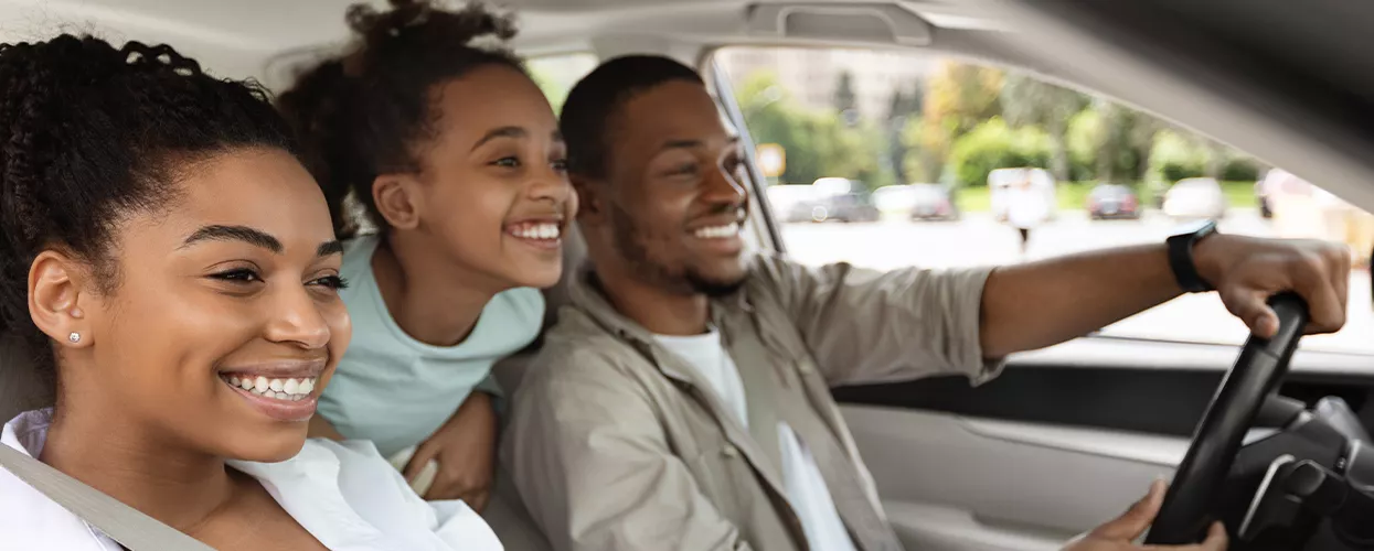 Family driving in their new Honda vehicle