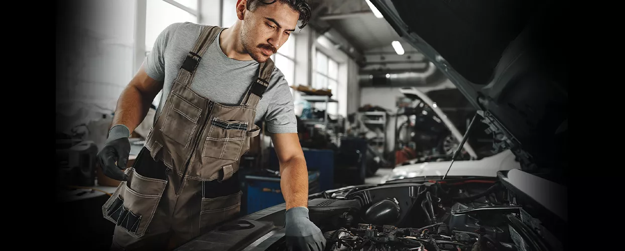 Volvo technician inspecting brake components in a service bay