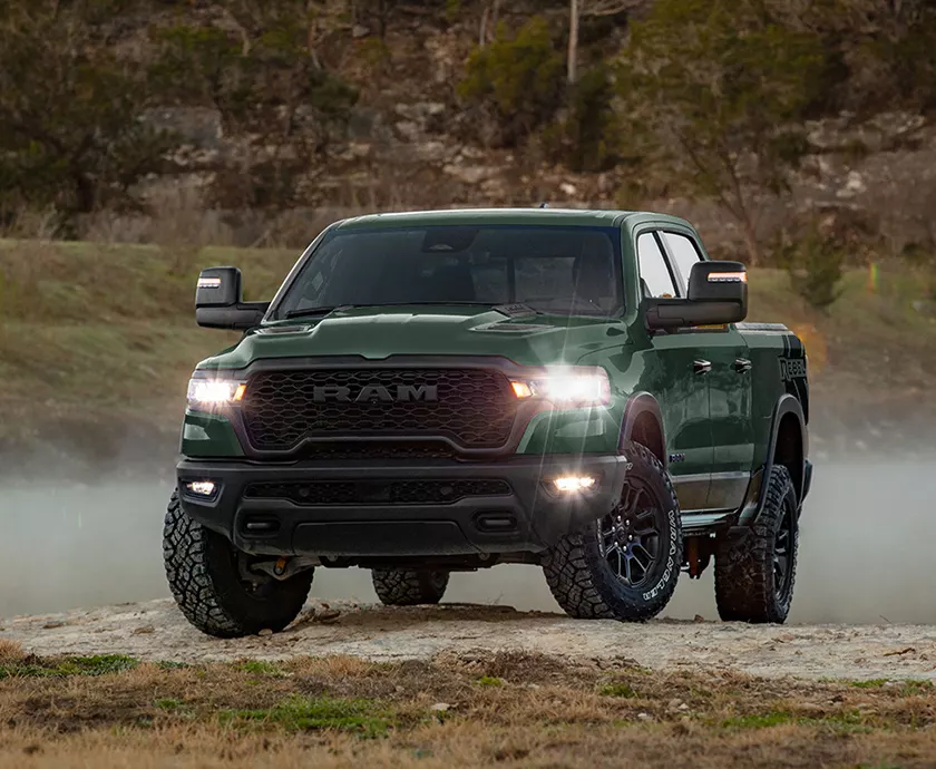 Front view of a green e 2026 RAM 1500 parked in the woods in Lithia Springs, GA