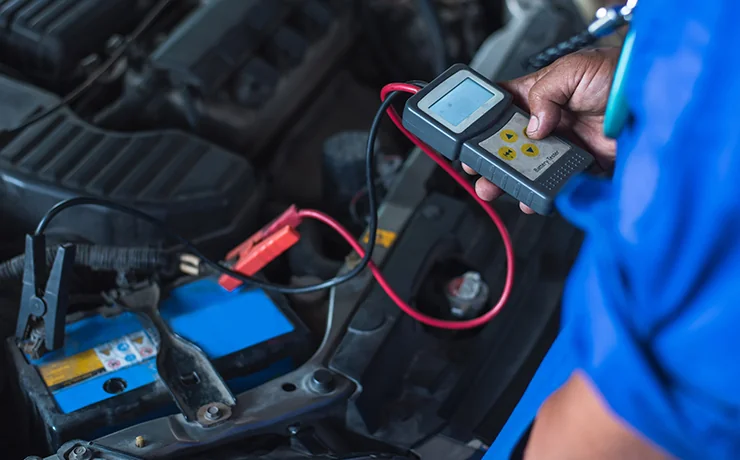 tech checking car battery