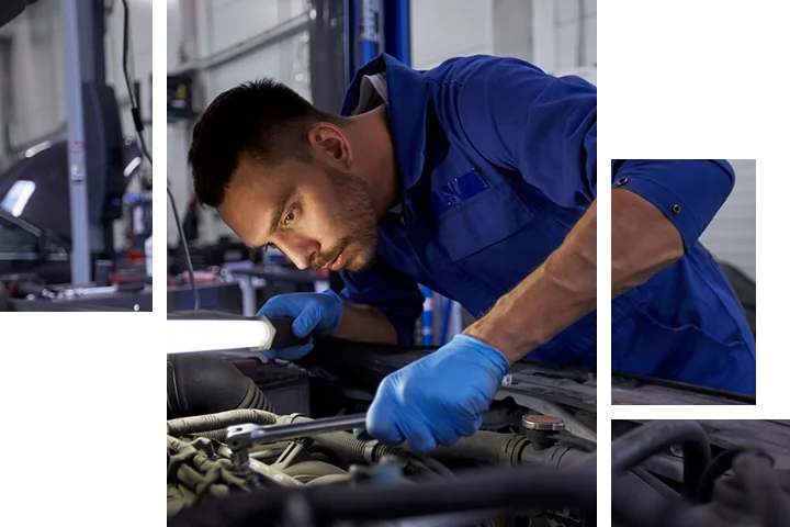 mechanic with a light working on an engine