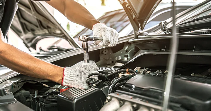mechanic working on a car with a wrench