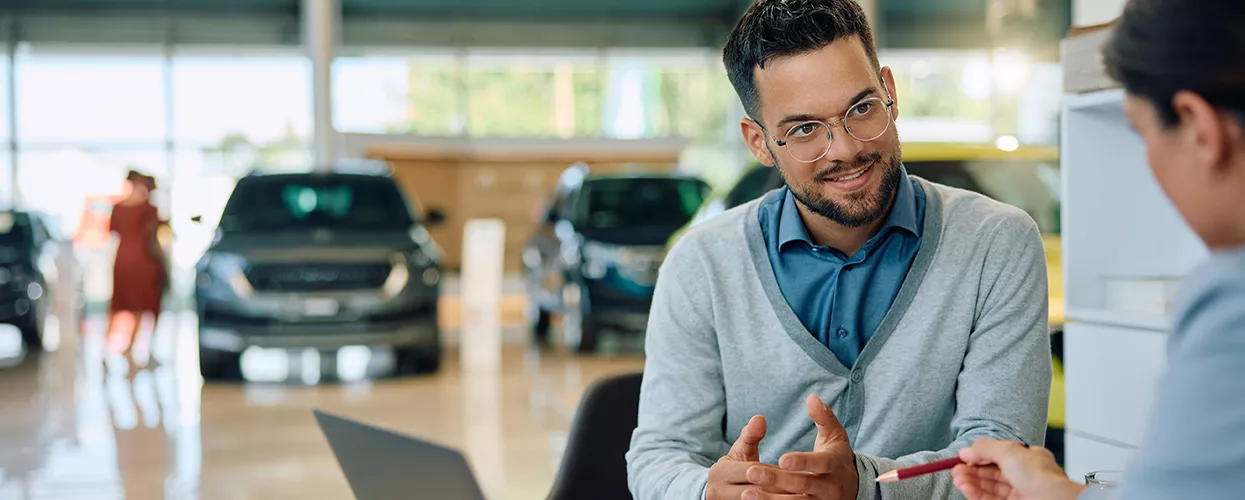 Car salesman and customertalking in a car dealership