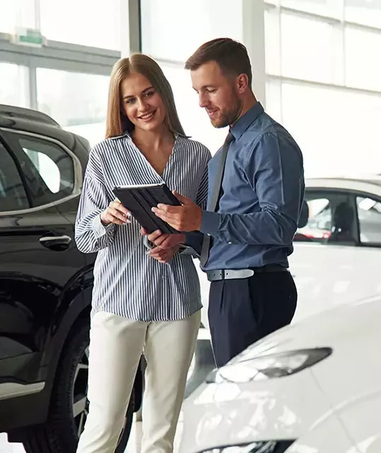 Customers reviewing vehicle financing information