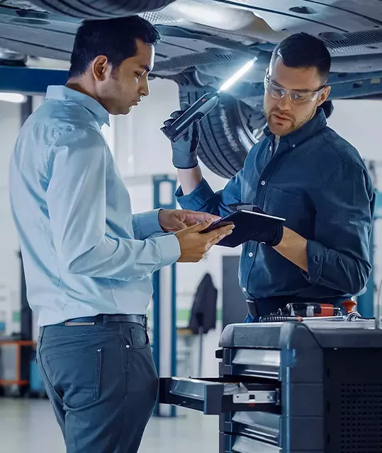 Technician servicing a vehicle