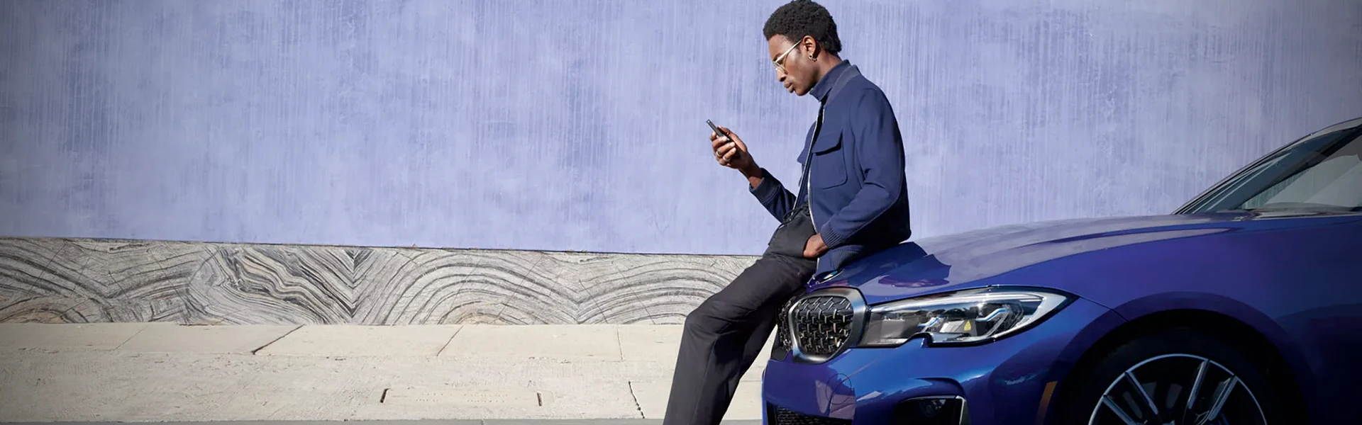 BMW owner leaning on his new BMW in Tampa
