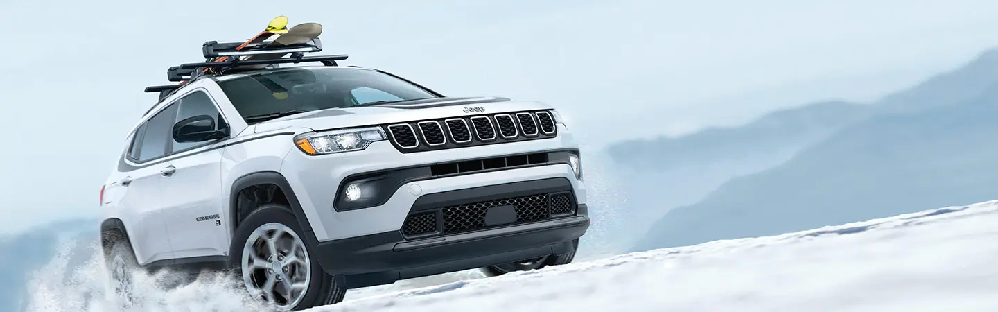 grey Jeep Compass on beach