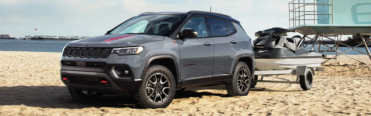 white Jeep Compass driving on road