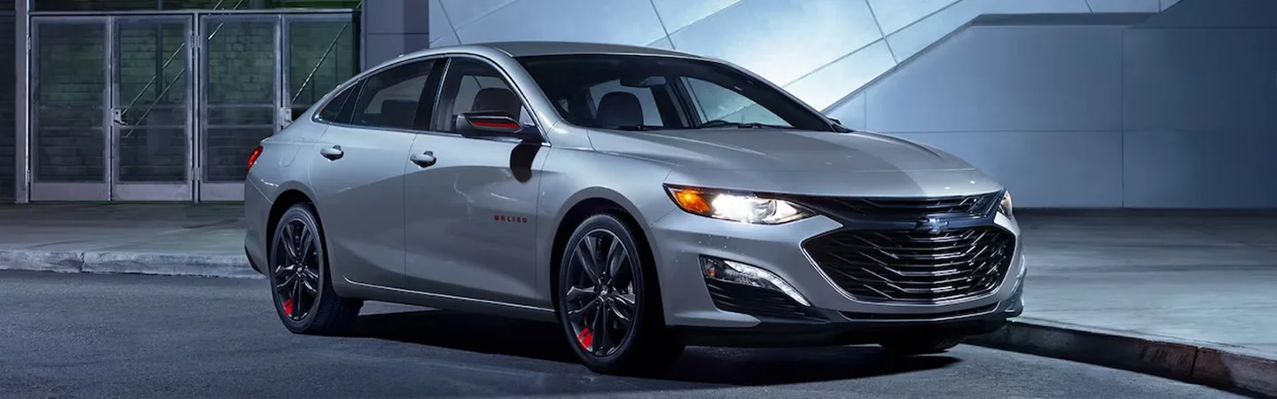 A parked silver 2024 Chevrolet Malibu on the street