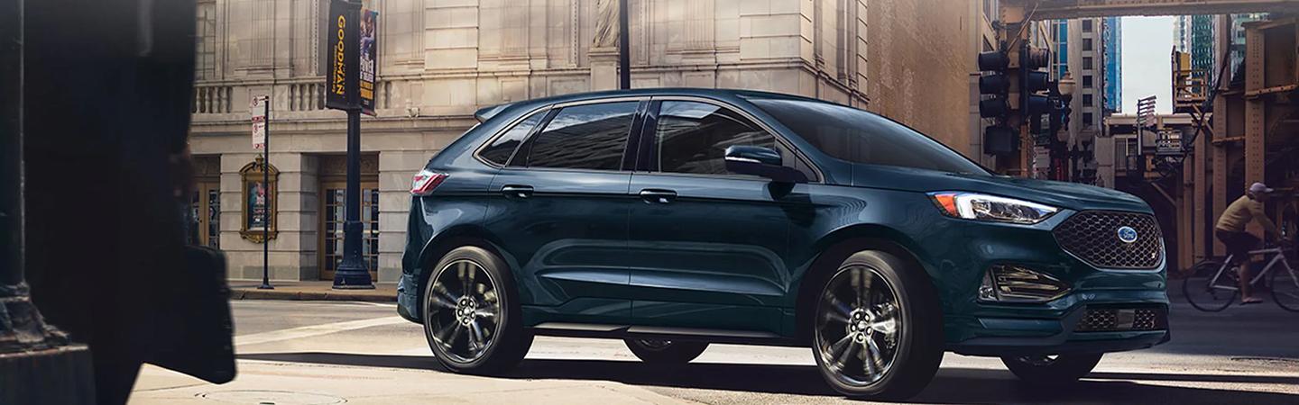 Side view of a 2022 Ford Edge driving in the city