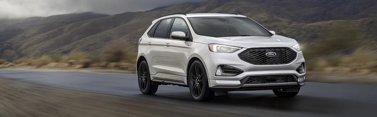 Front view of a 2022 Ford Edge driving on a road