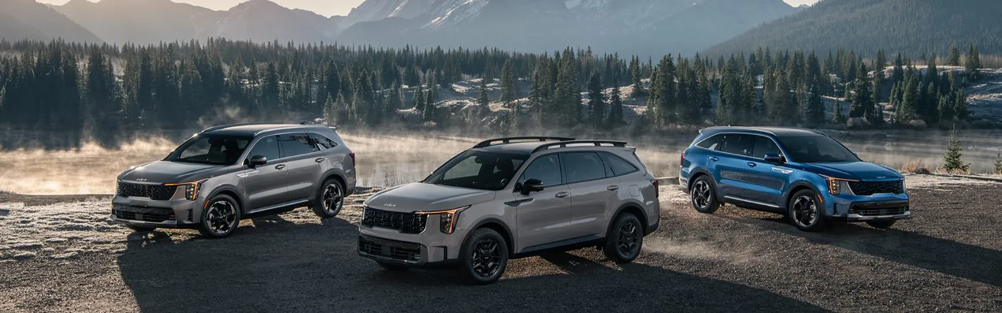 Model line of 2025 Kia Sorento Hybrid by a lake and woods