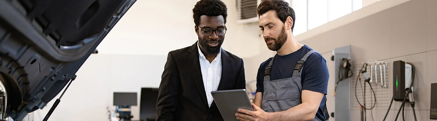 car mechanic showing customer information on repair