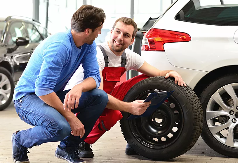 Certified Kia technician servicing a vehicle at Crown Kia St. Pete
