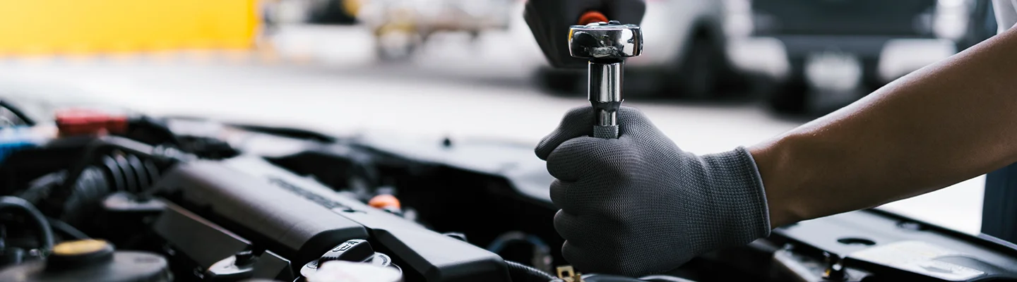 tech using wrench on engine