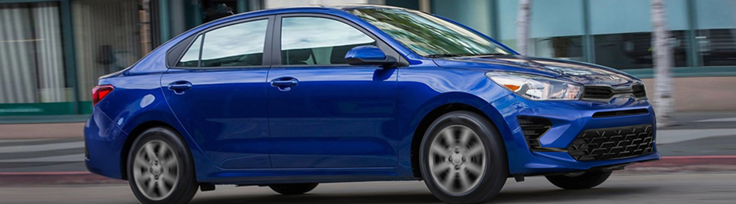A blue 2021 Kia Rio in motion