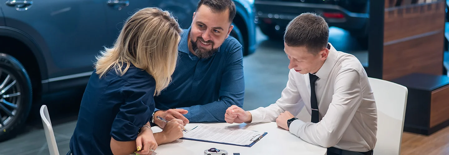 Sales person talking to customers about buying a Porsche E-Hybrid Models Near Clearwater, FL Today