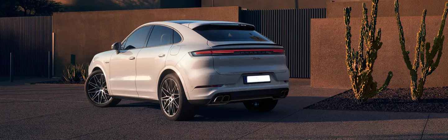 Back view of a parked 2025 Porsche Cayenne in a driveway
