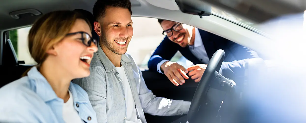 explaining interior of new car to customer