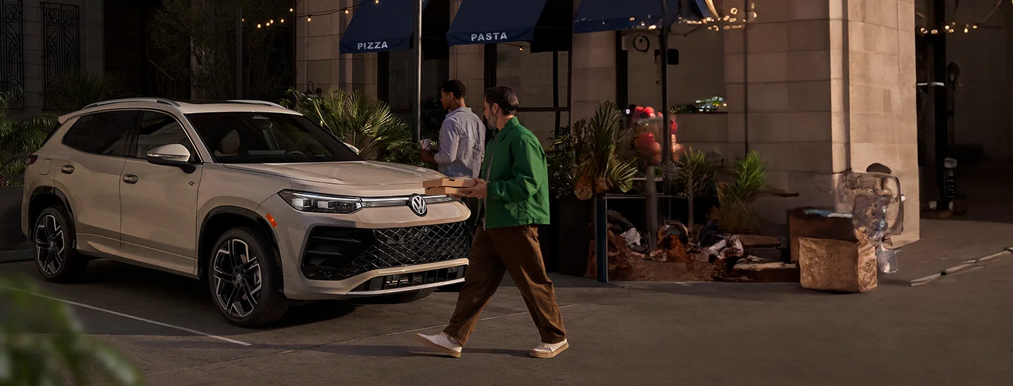 walking to the 2025 Volkswagen Tiguan