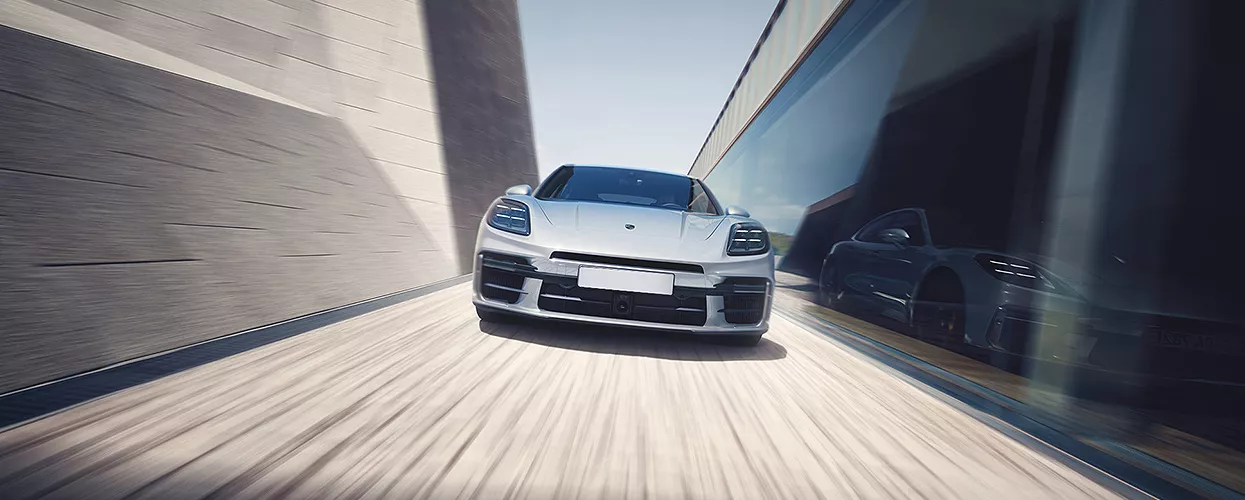 Porsche hybrid sports car driving along a coastal Tampa road