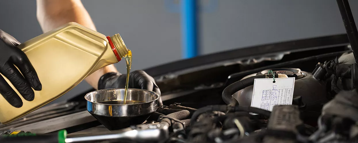 Service mechanic performing an oil change
