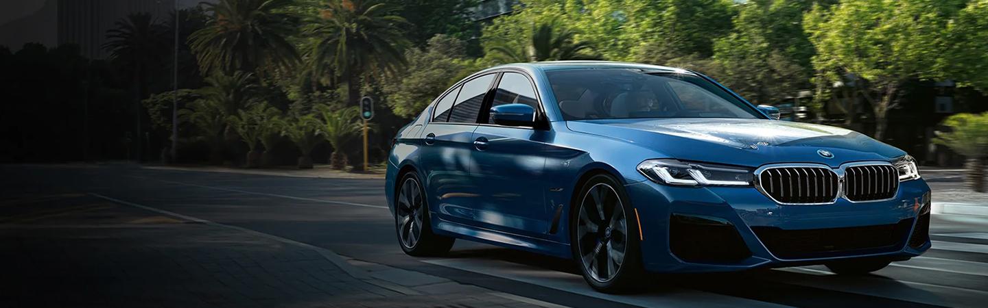 2022 BMW 5 Series driving in the street