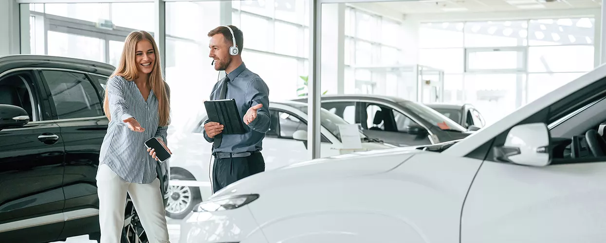 two people discussing a new car purchase