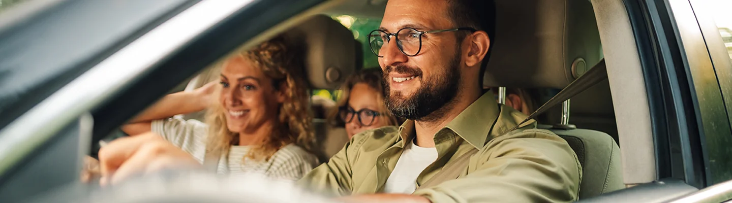a couple very happy with their car purchase smiling in car interior view