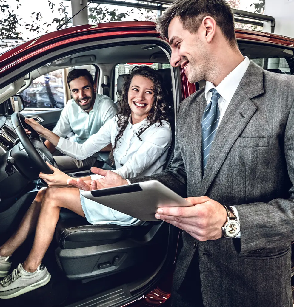 sales rep showing a new car