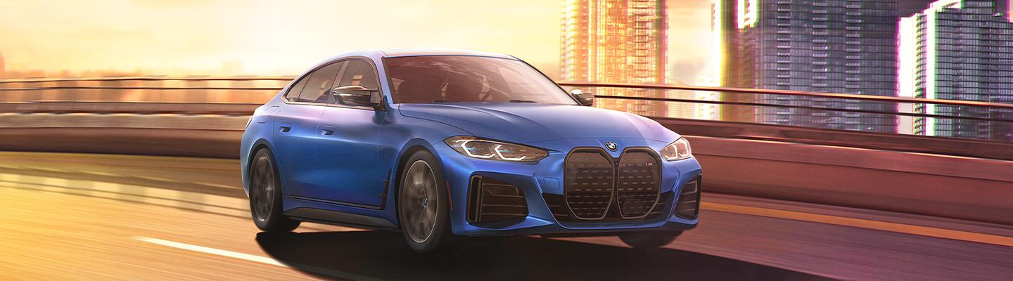 Blue 2022 BMW i4 on city highway