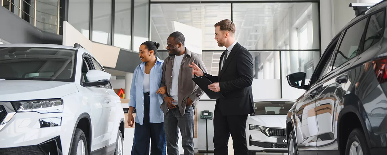 Couple looking at a new vehicle at a Land Rover dealership