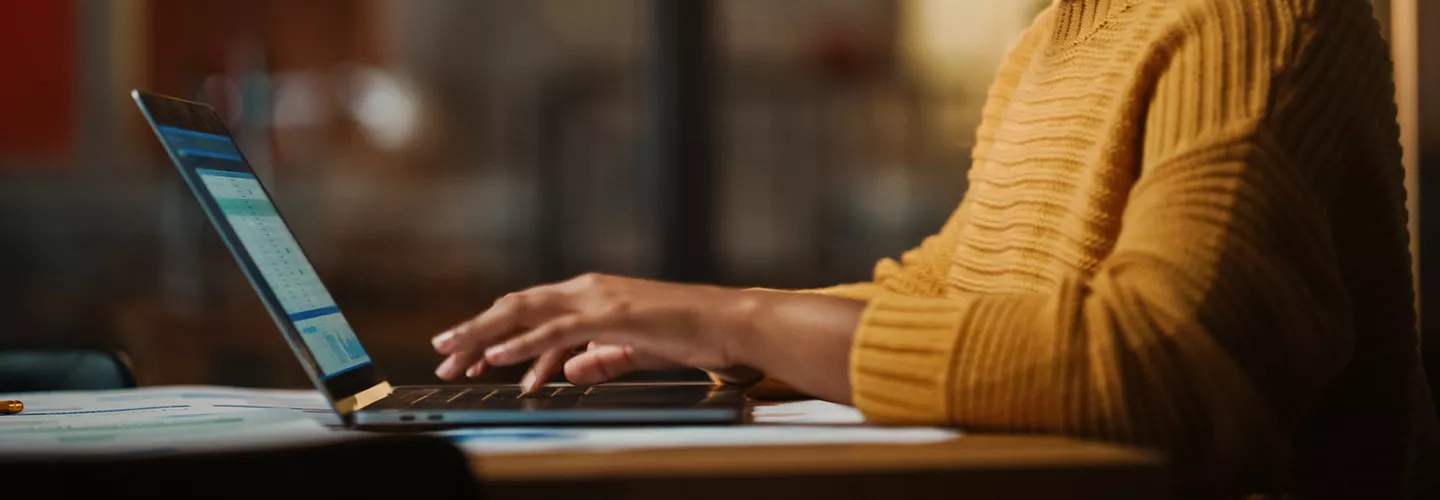 Woman looking at a laptop at her home