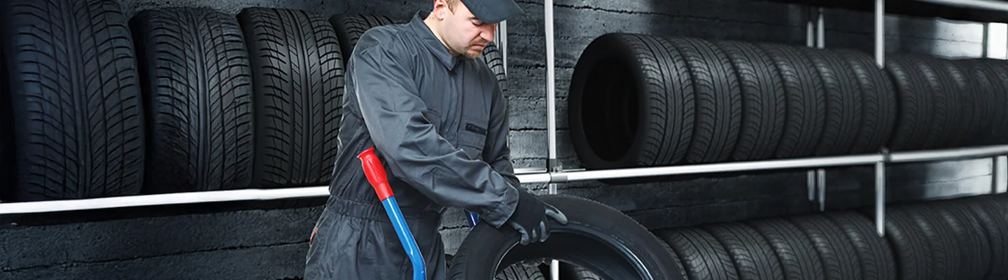 Mechanic changing a tire on a vehicle