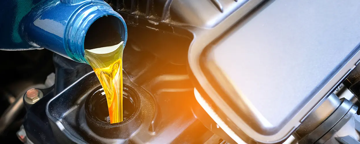 pouring oil in crank case