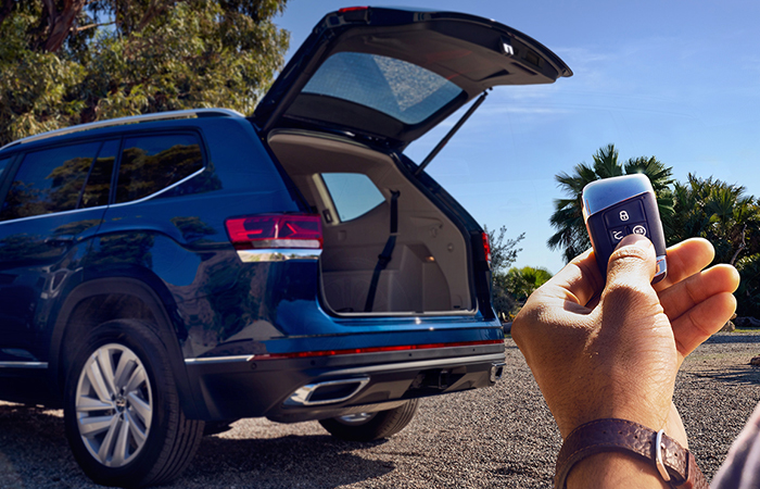 A person using a keyfob to open the back of a Volkswagen Atlas 