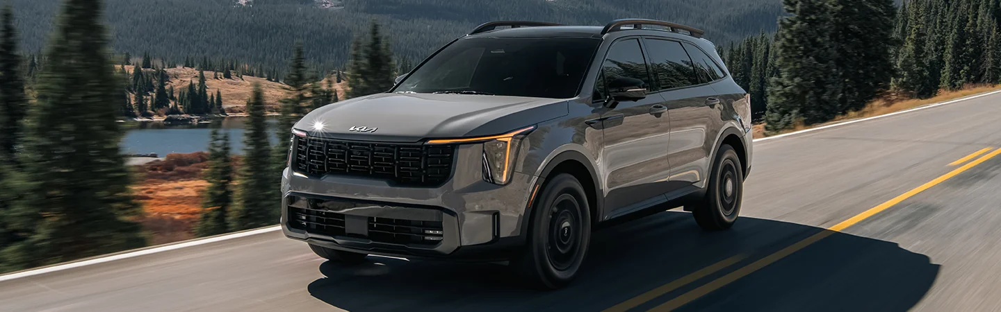 gray 2025 Kia Sorento driving in mountain road